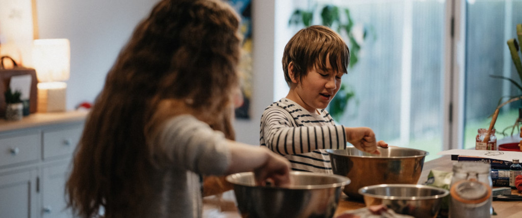 photograph of two children cooking in a kitchen